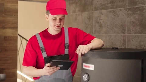 Plumber Inspecting Water Heater With Tablet Showing Thumbs Up Stock Footage 330858973