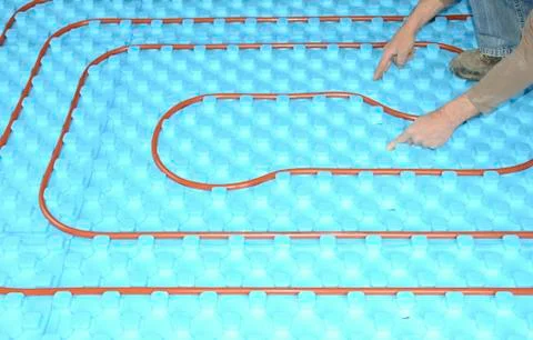 Plumber installing a floor heating Stock Photos