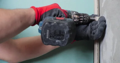 Plumber installing pipes of water supply system using electric screwdriver and Stock Footage 150723637