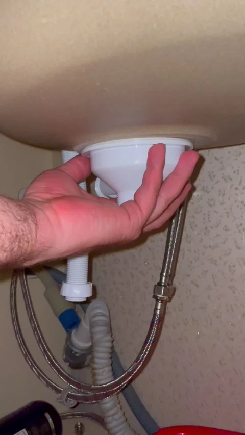 Plumber installing sink drain pipe under basin. Man fixing kitchen plumbing Stock Footage 340124664
