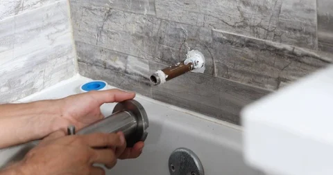 Plumber installing water tap in bathroom Stock Footage 120670560