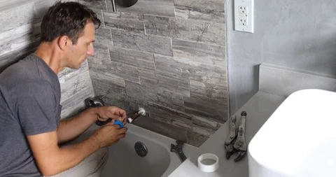Plumber installing water tap in bathroom Stock Footage 120670582