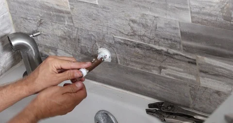 Plumber installing water tap in bathroom Stock Footage 120670594