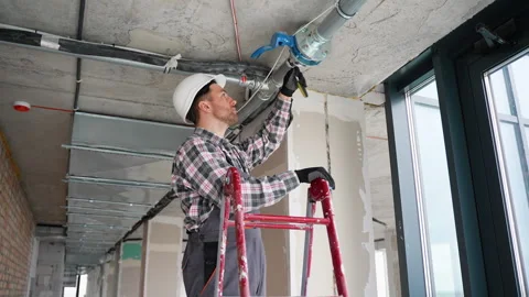 A plumber installs a fire protection pipe Stock Footage 314564289