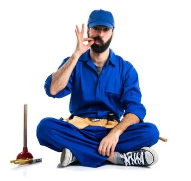 Plumber making silence gesture Stock Photos