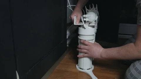 Plumber or Man hand replace cartridges for water filter in home kitchen. Fixed Stock Footage 129188989