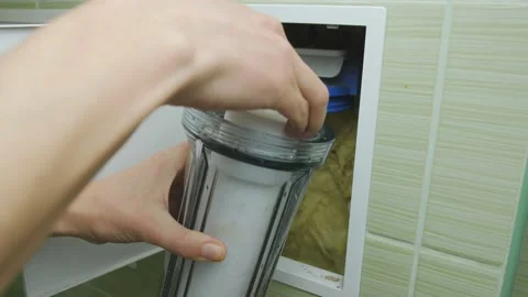 Plumber or Man hand replace cartridges for water filter in home kitchen. Fixed Stock Footage 152375182
