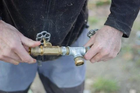 Plumber with pipe connectors Stock Photos