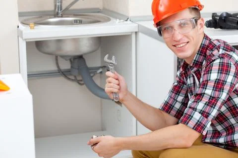 Plumber with pipe wrench Stock Photos