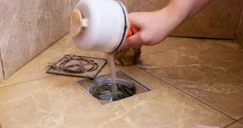 Plumber pulls an old dirty filter out of shower drain using pliers. Stock Footage 224410199