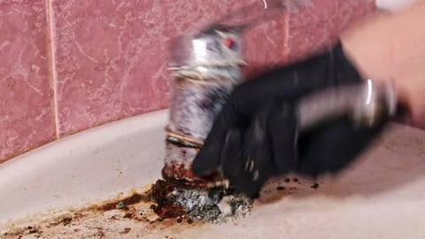 Plumber removing old rusty faucet from dirty bathroom sink Stock Footage 331886423
