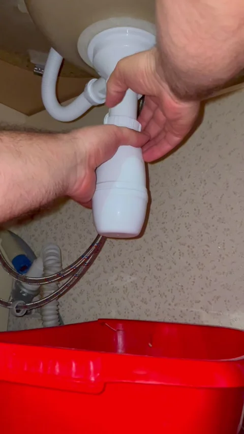Plumber repairing kitchen sink drain. Man installing plastic pipe trap system Stock Footage 340124698