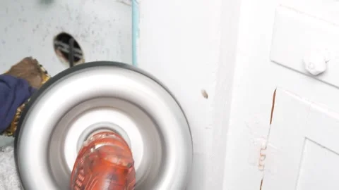 A plumber snaking the bathtub drain  Video stock 318577203