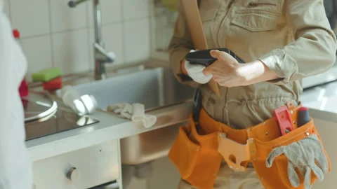 Plumber Taking Payment - Kitchen Repair Video stock 318934369