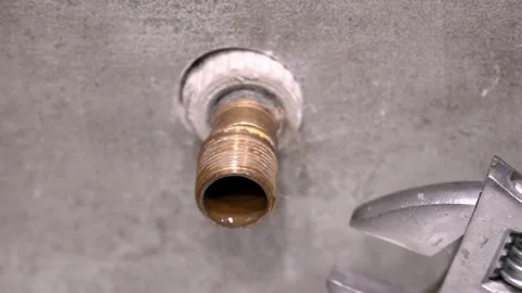Plumber tightening brass pipe fitting with adjustable wrench 스톡 동영상 304118521