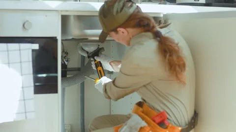 Plumber Tightening Pipe Under Kitchen Sink Stock Footage 310747744