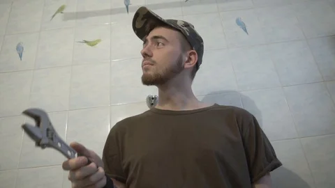 A plumber twists a wrench in his hands Stock Footage 108306583