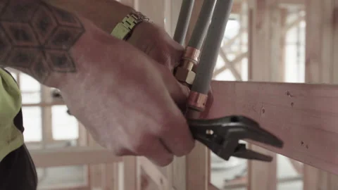 Plumber undoing coupling with spanner Stock-Footage 162869429