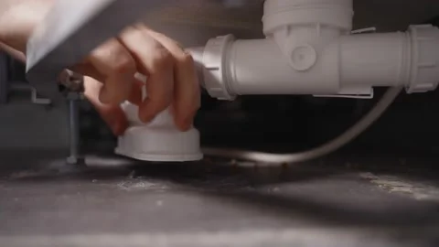 Plumber unscrewing bath trap. Close-up view. Stock Footage 152317638