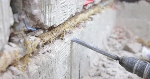 Plumber using a jackhammer to drill into wall, slow motion Stock Footage 196423986