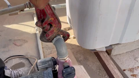 Plumber Using Pipe Wrench to Fix a Water Pump Video stock 345740974