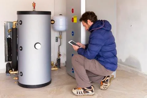 Plumber at work making the consumption metering Stock Photos
