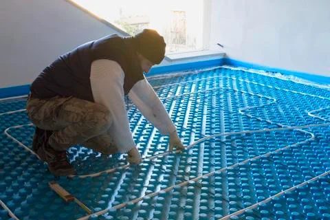 Plumber working installed system radiant floor Stock Photos