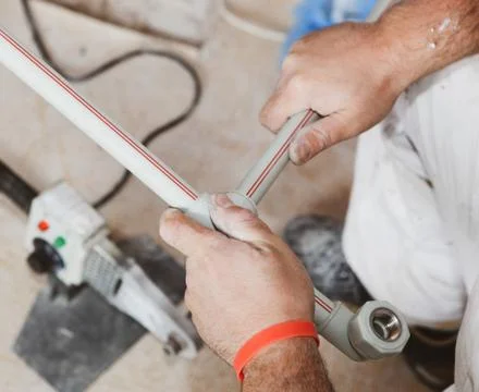 Plumber Working On Kitchen Sink Stock Photos