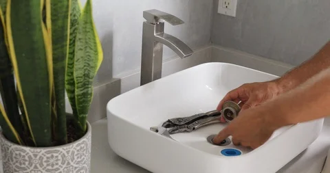 Plumber Working on Sink in Bathroom Stock Footage 120670590