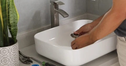 Plumber Working on Sink in Bathroom Stock Footage 120670605