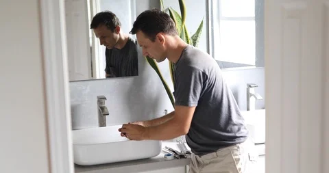 Plumber Working on Sink in Bathroom Stock Footage 120670623