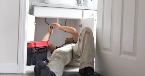 Plumber Working on Sink in Bathroom Stock Footage 120670625