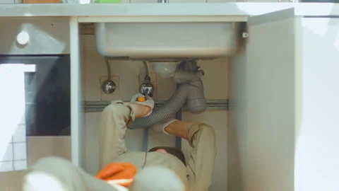 Plumber Working Under Kitchen Sink Stock Footage 309489501