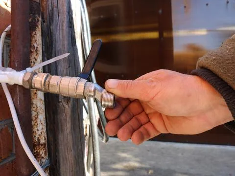 The plumber's hand checks the thread on the outer pipe Stock Photos
