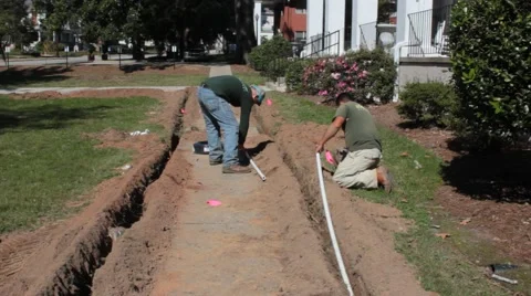 Plumbers Laying In-ground Piping Stock Footage 46890955