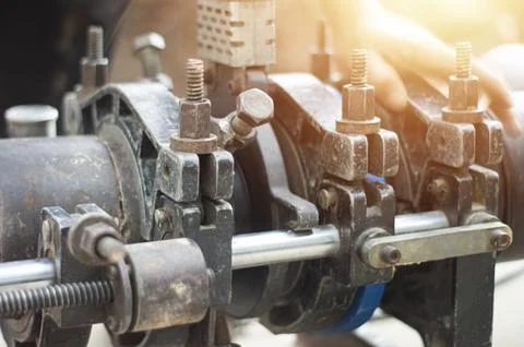 Plumbers use tools to connect large water pipes. Stock Photos