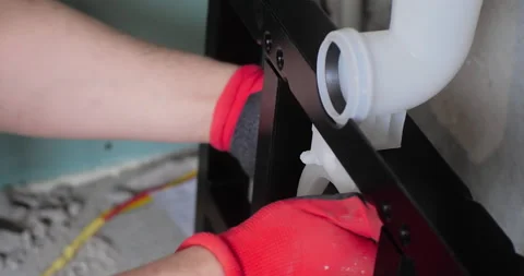 Plumbing installation. Close-up of a worker's hands in protective gloves Stock Footage 150724499