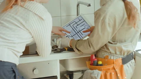 Plumbing Plan Discussion: Tablet in Kitchen Stock Footage 311075351