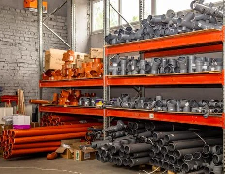 Plumbing store or supermarket. Plastic PVC and steel pipes and fittings in a Stock Photos