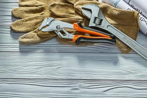 Plumbing tools adjustable monkey spanner and plumb bob spanner building gloves Stock Photos