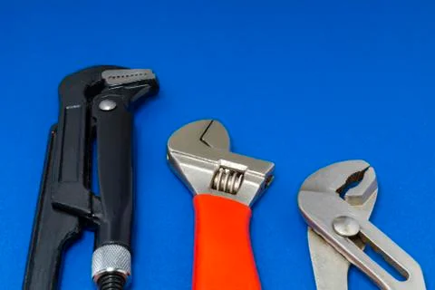 Plumbing work tools on a blue background. Stock Photos