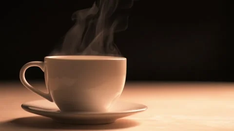 A plume of steam rises from a white ceramic coffee cup Video stock 293948360