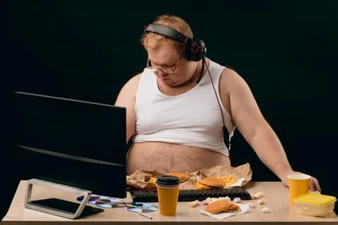 Plump computer programmer browsing the net Stock-Fotos