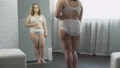 Plump girl with excess weight checking skin, looking for cellulite on body 4k or 4k+ Resolution