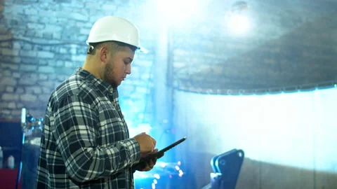 Plump male employee using tablet in factory workshop Stock Footage 152488340