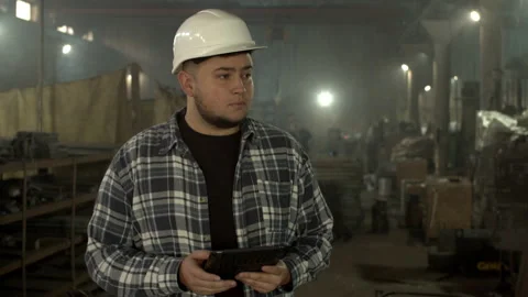 Plump male employee using tablet in factory workshop Stock Footage 152488810