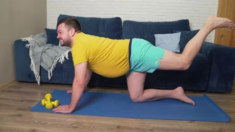 Plump man with beard is doing physical exercise for weight loss. Stands on Vídeos de archivo 170608608