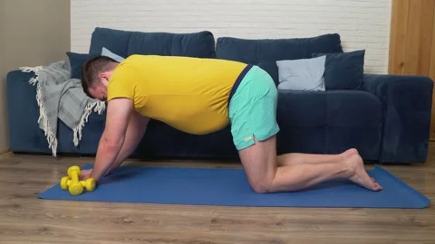 Plump man with beard is doing physical exercise for weight loss. He sits on Stock Footage 170608697