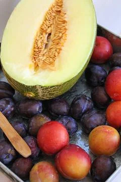 Plums and melon Stock Photos