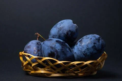 Plums on a black background. Stock Photos